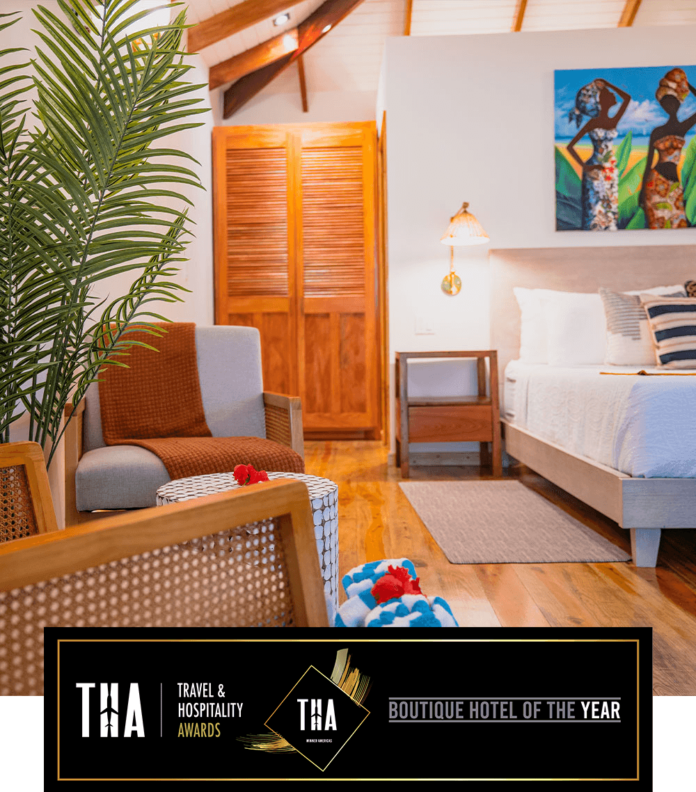 Stylish boutique hotel room featuring a cozy seating area and vibrant wall art.